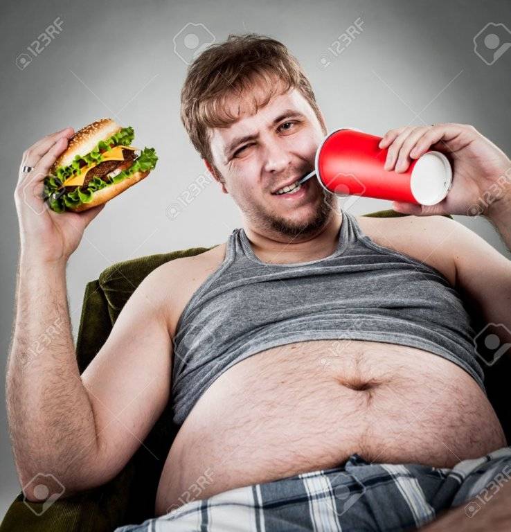 14569667-fat-man-eating-hamburger-seated-on-armchair-stock-photo-overweight-jpg.jpg