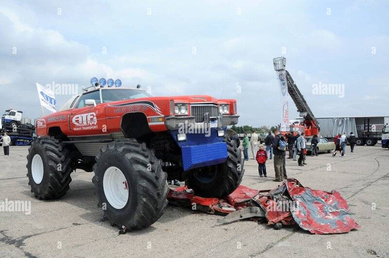 cadillac-monster-truck-parked-on-crushed-car-BCWWMR~2.jpg