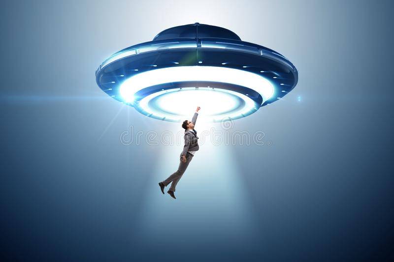 flying-saucer-abducting-young-businessman-151858820.jpg