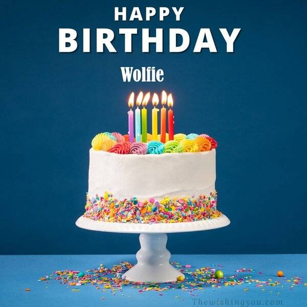 Happy-Birthday-Wolfie-written-on-image-White-cake-keep-on-White-stand-and-burning-candles-Sky-...jpg