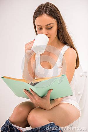 woman-toilet-young-reading-book-sitting-58001192.jpg